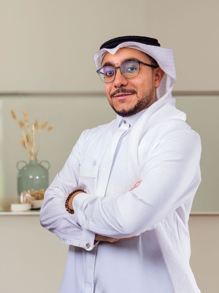 A professional profile section for Dr. Fadi Hassanin, an Oculoplastic Surgeon and Assistant Professor of Ophthalmology. The image features Dr. Hassanin wearing traditional Saudi attire, smiling confidently with his arms crossed. The accompanying text highlights his qualifications, including his role as an Assistant Professor at the University of Jeddah, Saudi Board certification in Ophthalmology, and specialized fellowship in Oculoplastic and Orbital Surgery. The section also lists his medical expertise and specializations.